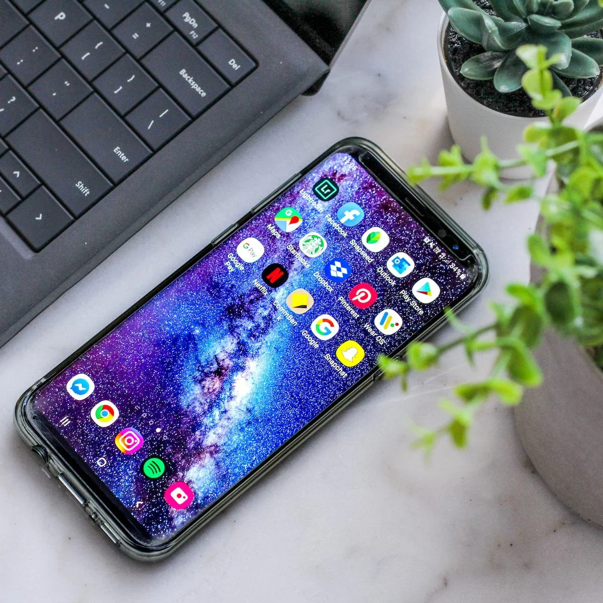 a smartphone phone with a phone in front of a laptop
