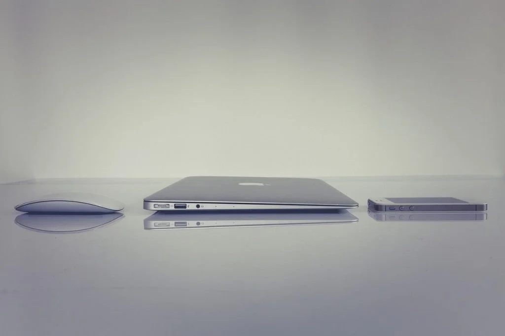 a laptop computer sitting on a table with a mouse and mouse